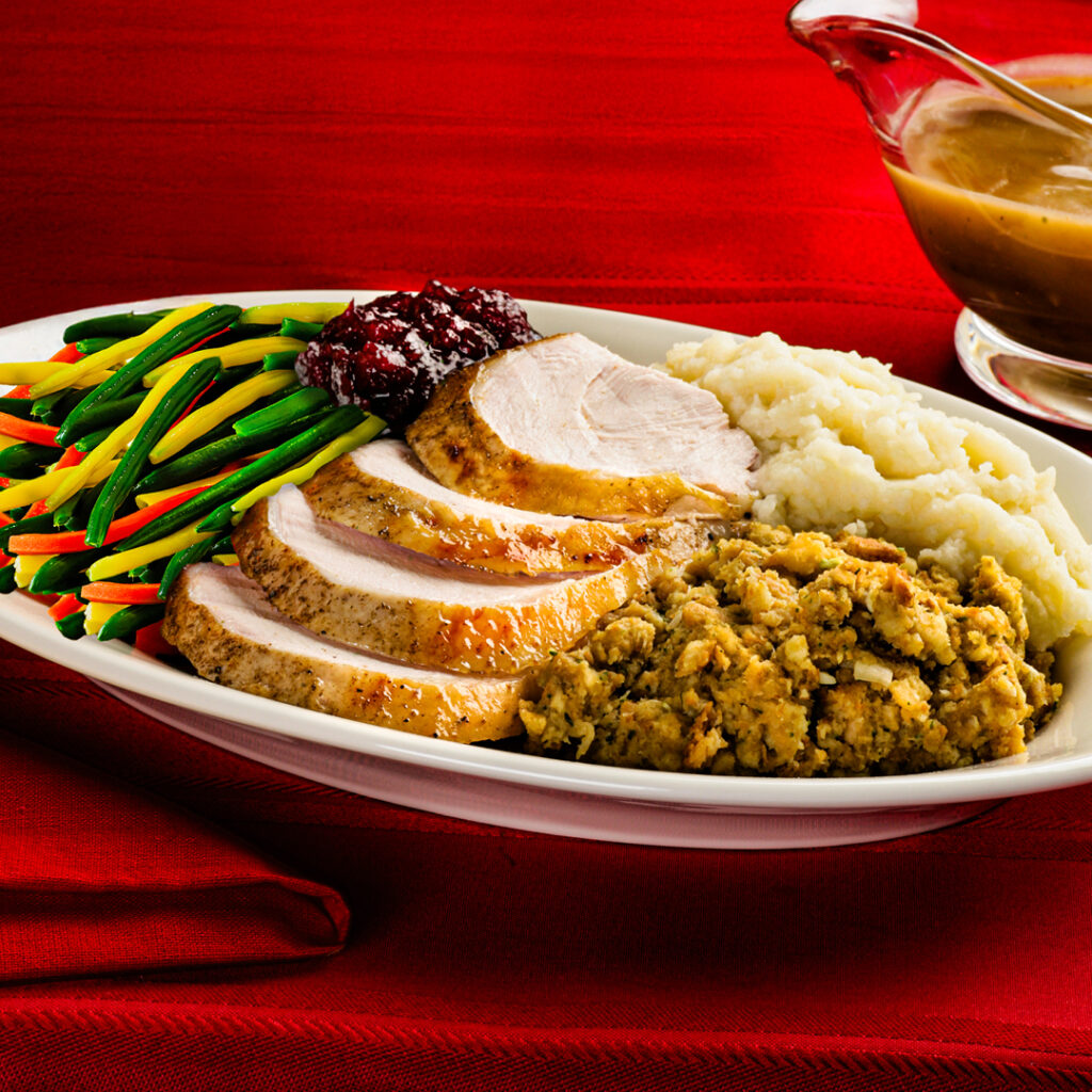 Sliced turkey, stuffing, vegetables, and mashed potatoes from Planet Hollywood for Thanksgiving